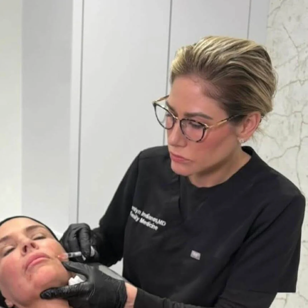 Dr. Carolyn Indianos, MD performing aesthetic treatment on a patient — Bespoke Aesthetics, Gainesville, FL